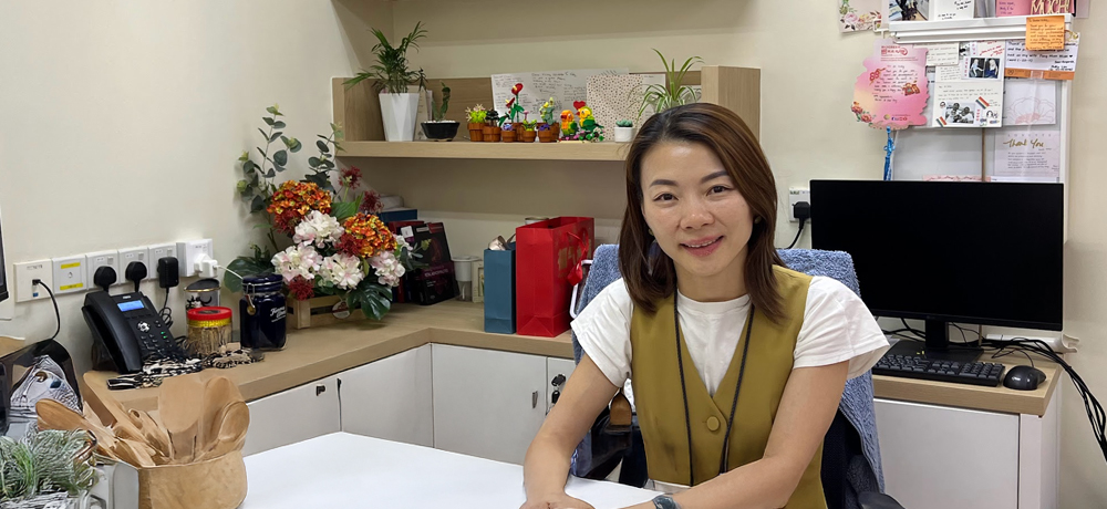 Dr Vicky Ho, Consultant Obstetrics and Gynaecologist (O&G) sitting in her clinic